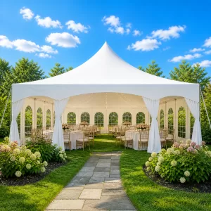 White high peak frame tent set up for a wedding reception in a garden backyard in Buffalo NY with chiavari chairs, round tables, white linens, bistro string lights, and cathedral window sidewalls