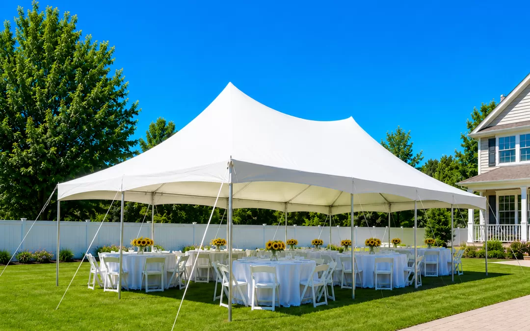 White frame tent rental set up for a backyard party in Williamsville NY with round tables, white chairs, and sunflower centerpieces